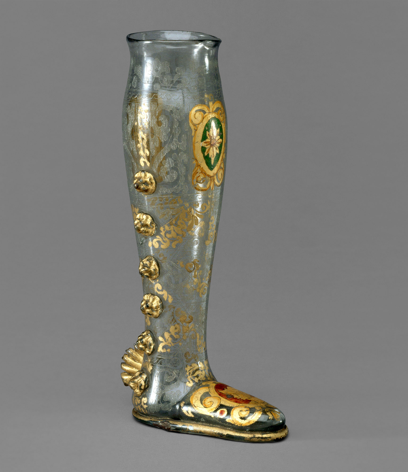 Glass boot-shaped vessel with gold decorations