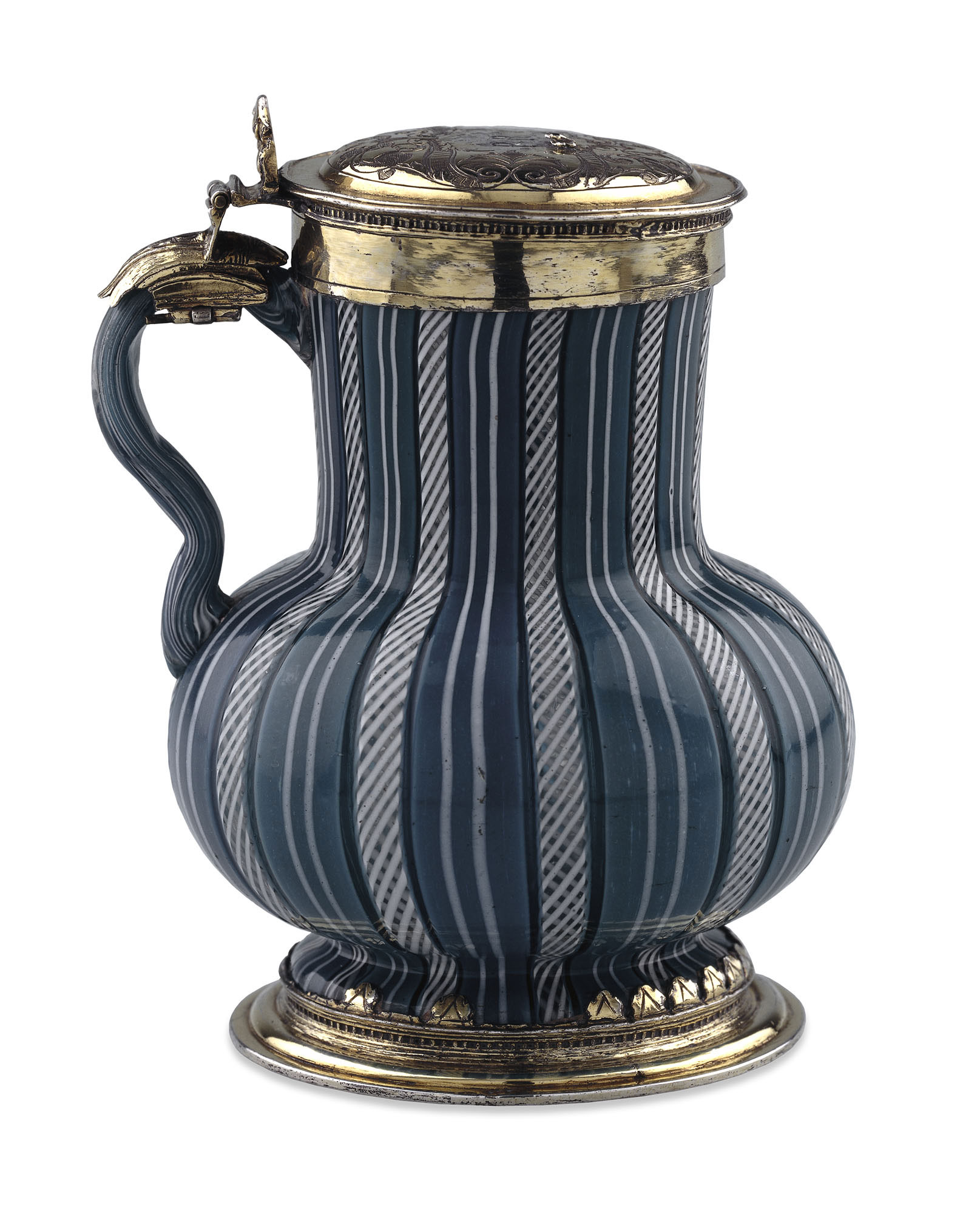 Glass tankard with rounded bottom and long straight neck covered in vertical turquoise stripes with silver lid and base