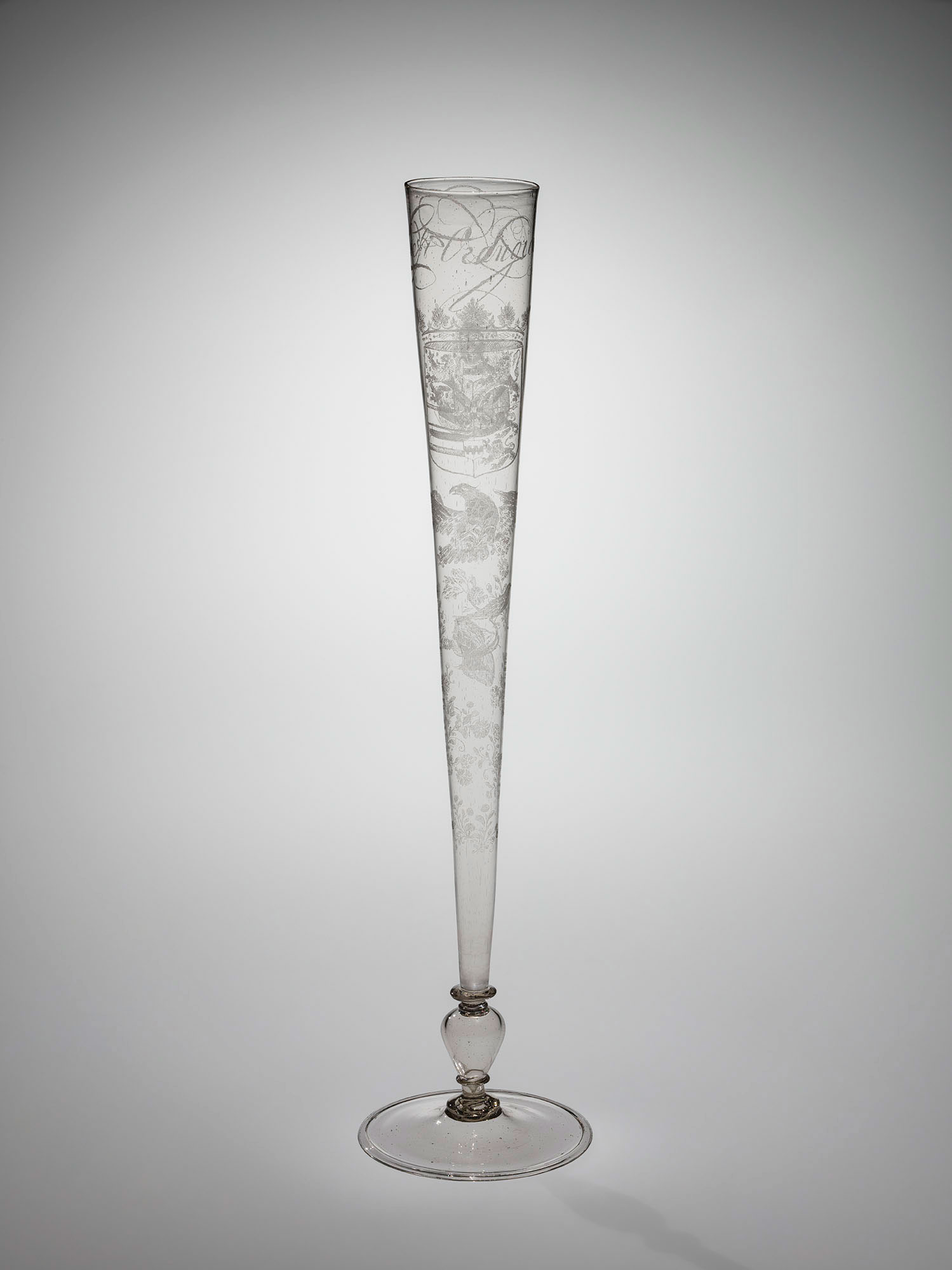 Tall, thin, clear glass flute engraved with a portrait of the William III, prince of Orange