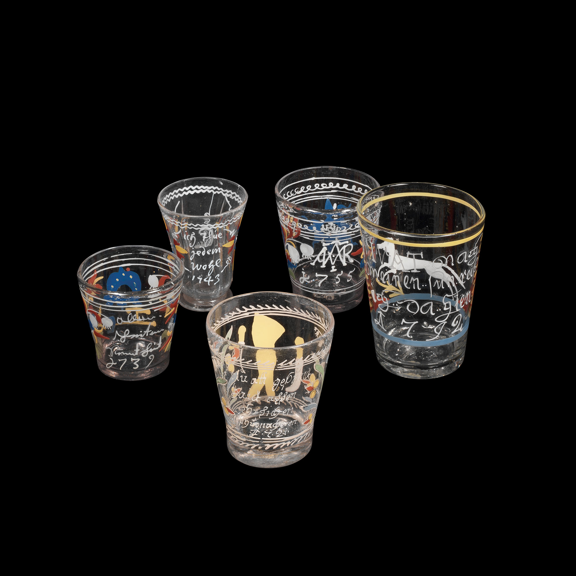 Five clear glasses decorated in enamel