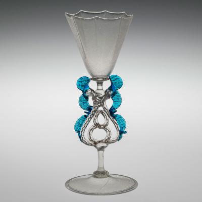 Clear goblet with decorative stem and blue "wings" along each side of the stem