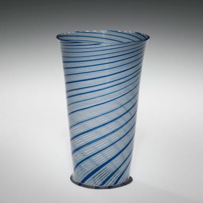 Thin, clear glass with white and blue spiral stripes around the vessel