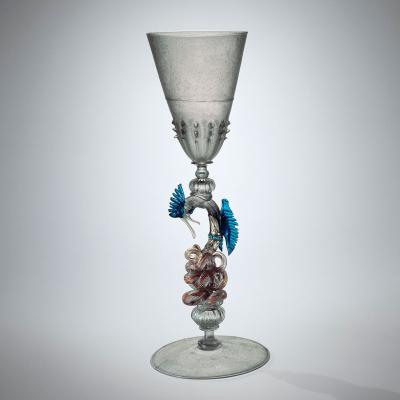 Colorless glass goblet with decorative stem shaped into a dragon with blue wings 