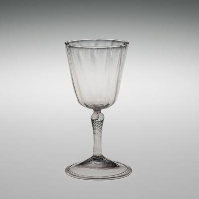 Clear wineglass; bowl has slight vertical ribbing and stem has diagonal ribbing